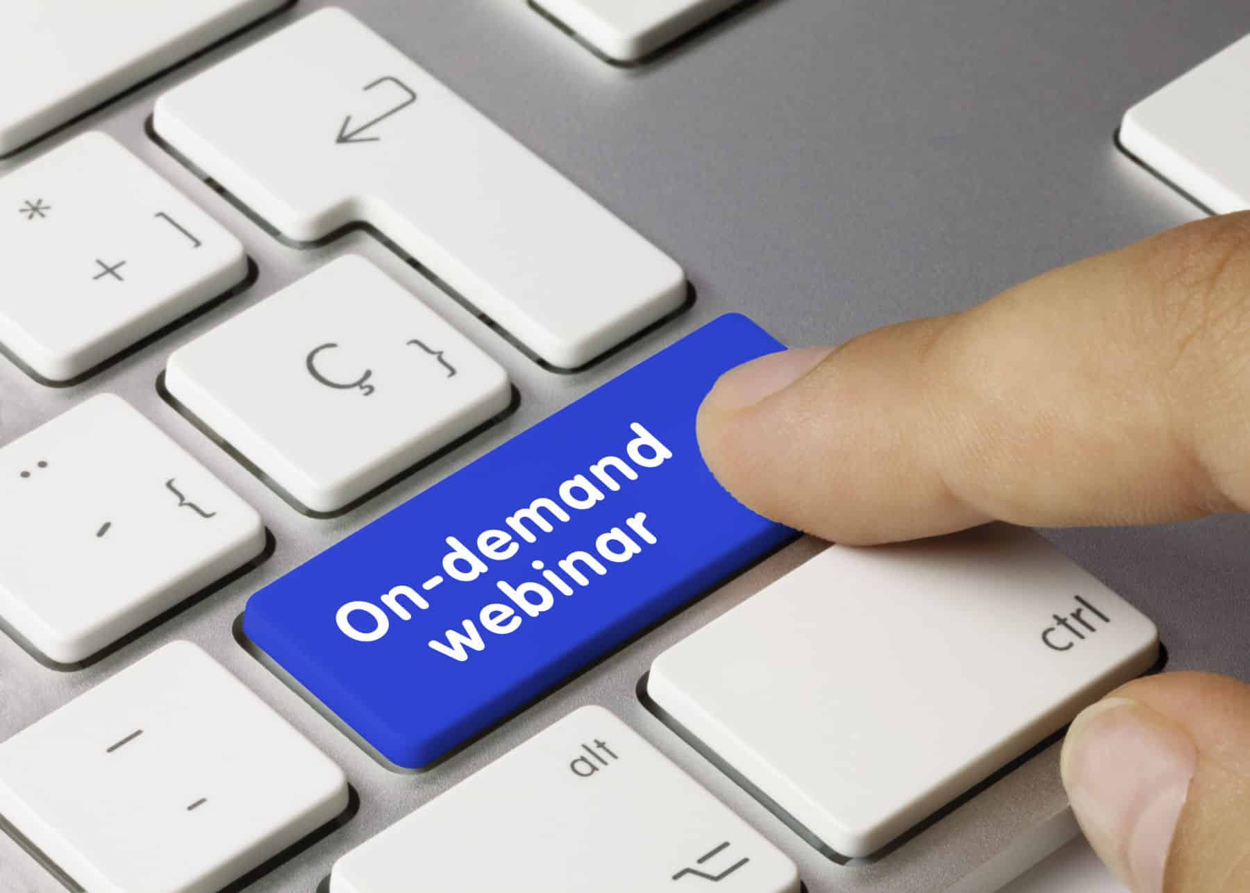 On-demand webinar Written on Blue Key of Metallic Keyboard. Finger pressing key.